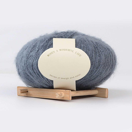 Blue mohair yarn ball with label on wooden holder