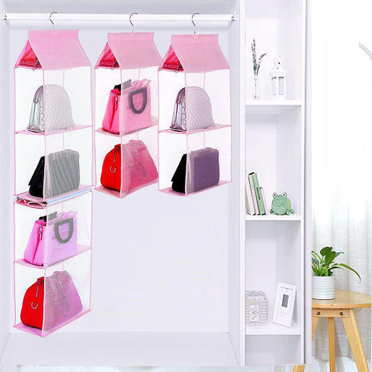 Pink hanging purse organizer with four mesh shelves, hooks attached to bar