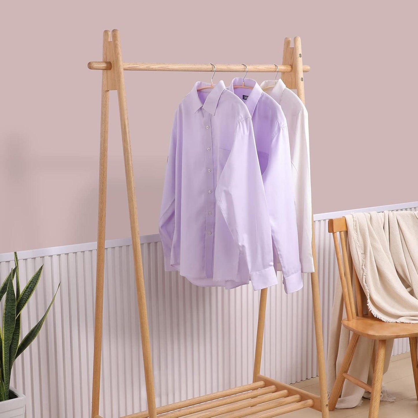 Clothes hanger rack with light-colored dress shirts on slim wooden hangers