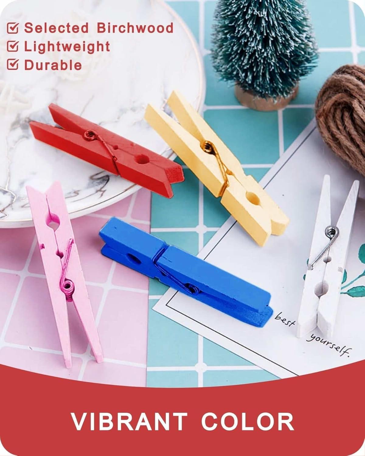 Assorted-color wooden clothespins with metal spring hinges, flat layout view