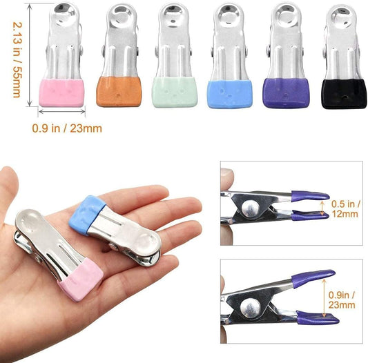 Set of metal clothespin clips with colored pads and spring clamp jaws.