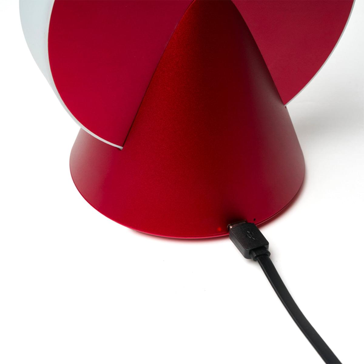 Red portable LED lamp with a black power cable connection at the base