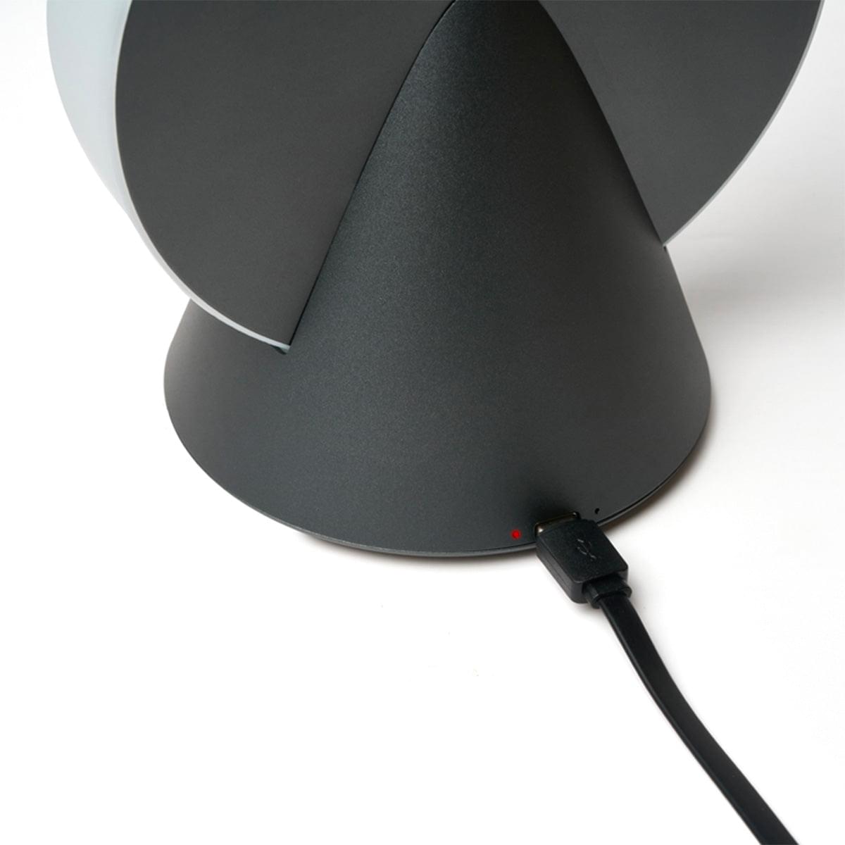 Lexon portable LED lamp with dark grey body and visible power cable connection