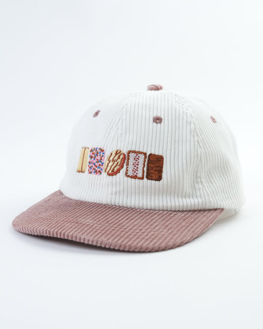 Knit cap with 'AUSSIE' letter patch and ribbed mauve brim, side view