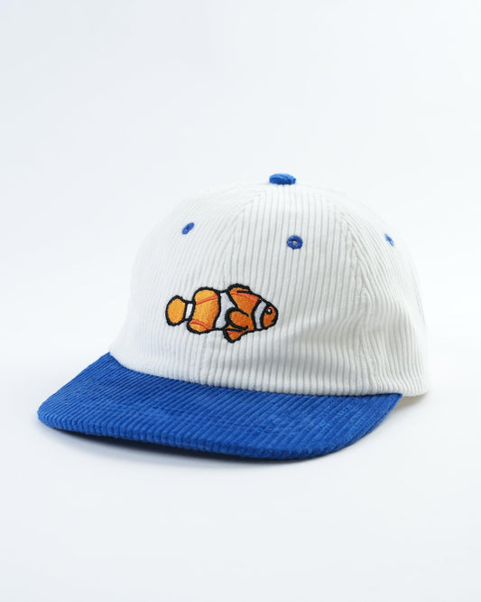White rib-knit cap with blue brim, orange fish patch, and small blue embroidered dots