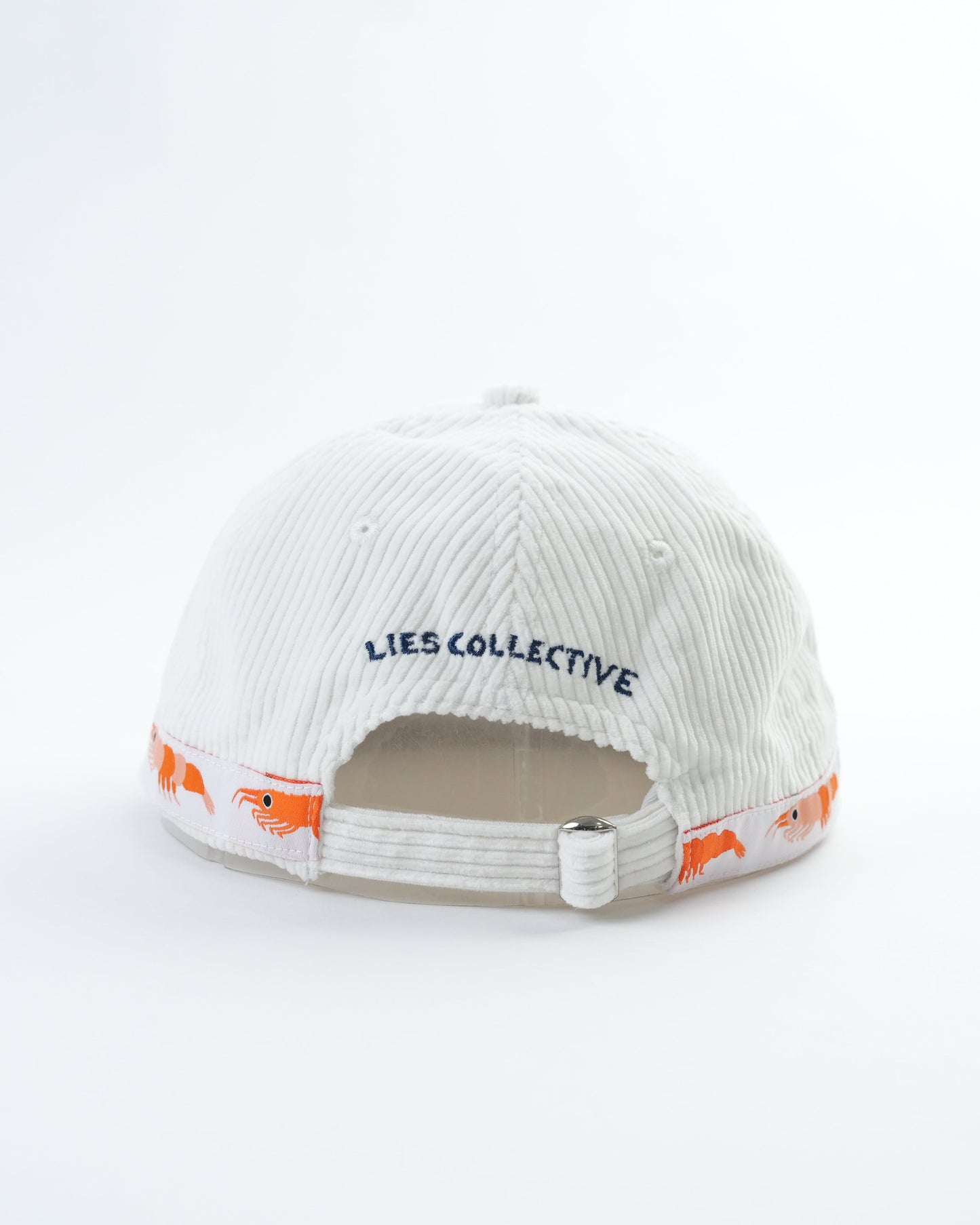 White cap interior view with LIES COLLECTIVE text and orange fish graphics