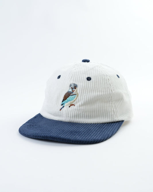 Vintage kookaburra cap with white ribbed crown, navy brim, and bird patch on side