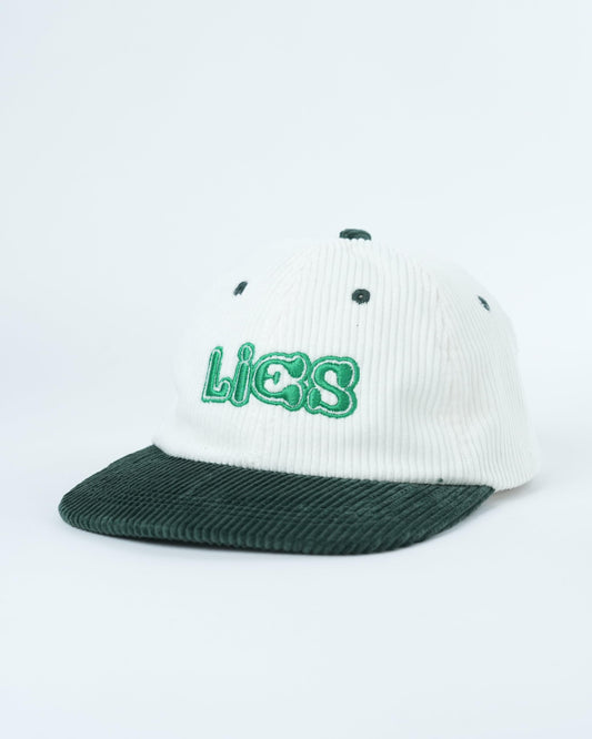 White ribbed baseball cap with dark green brim and green Lies logo front