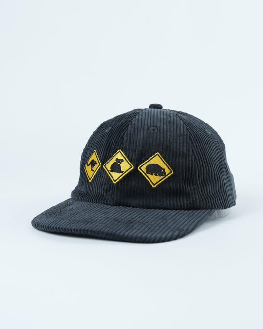 Dark gray cap with yellow wildlife patches across front panel, side angle view