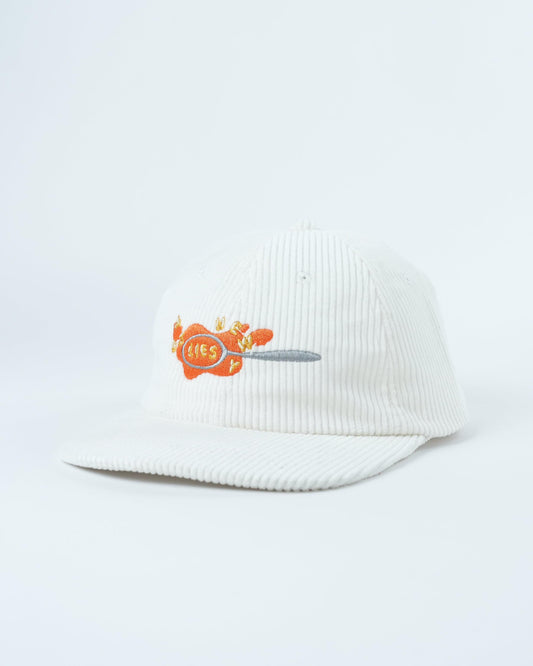 White knit beanie hat with orange crab graphic on side