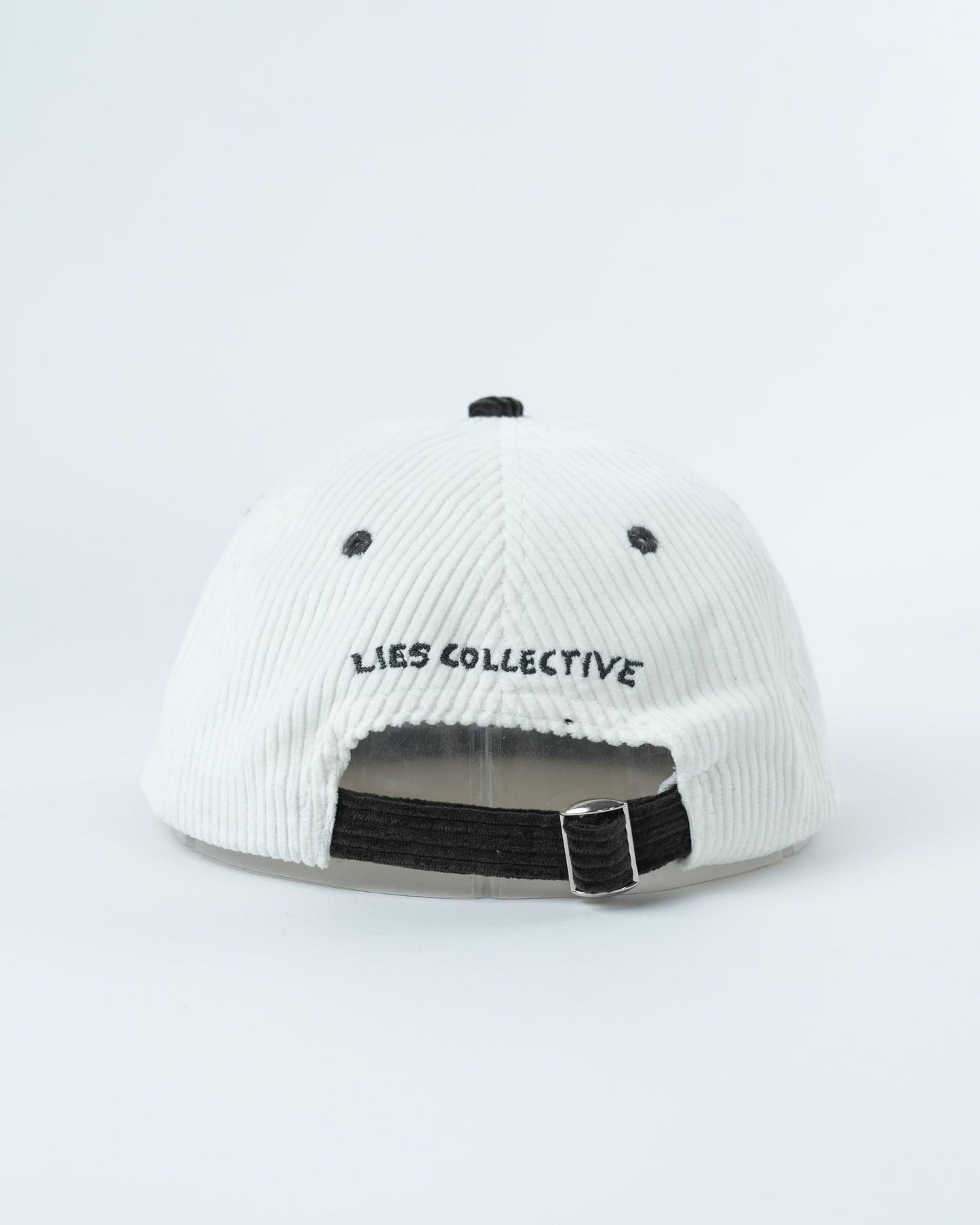 White ribbed cap with dark adjustable strap, LIES COLLECTIVE text on back