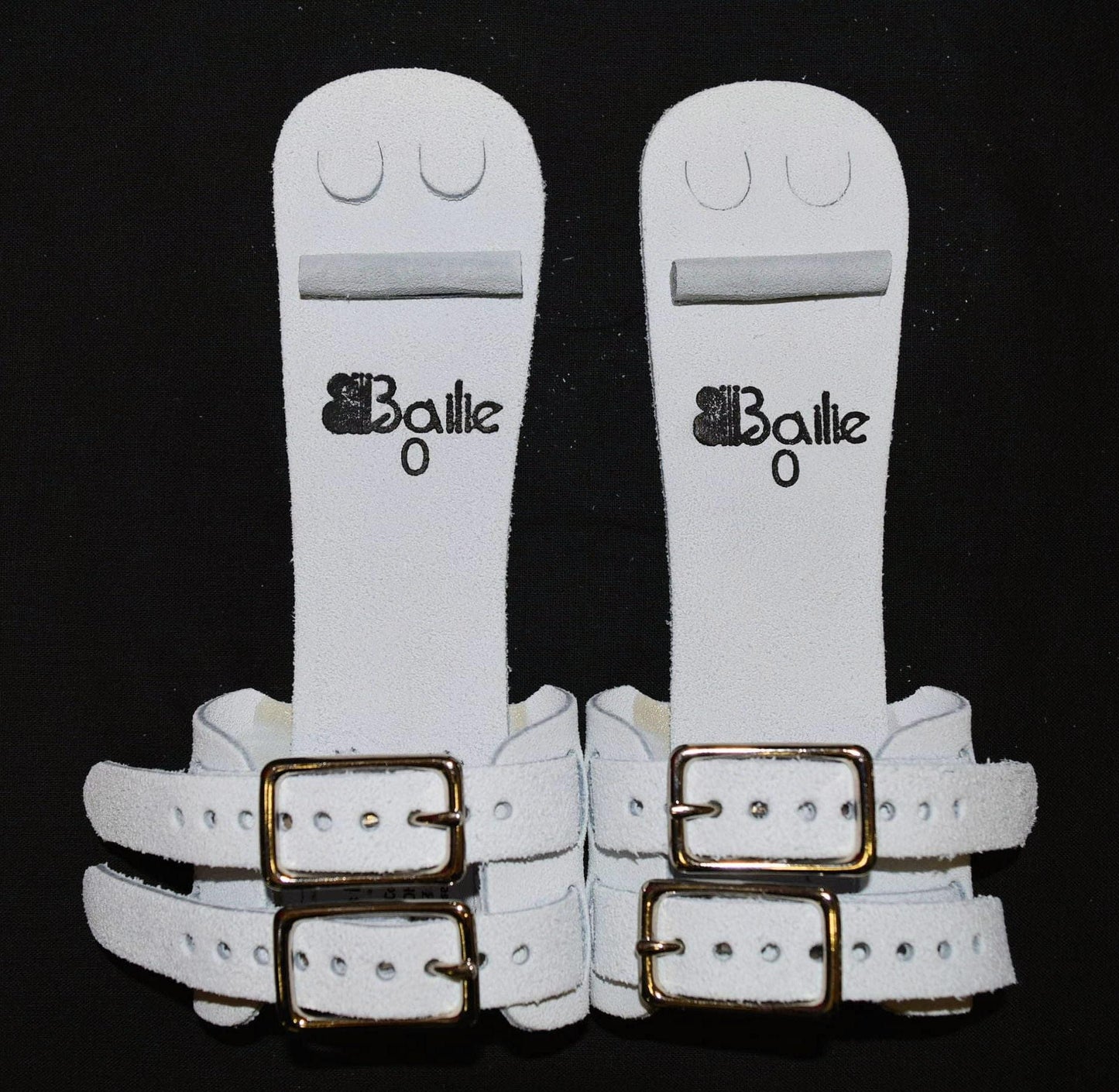 White dowel grips pair with Bailie logo and double gold buckle straps