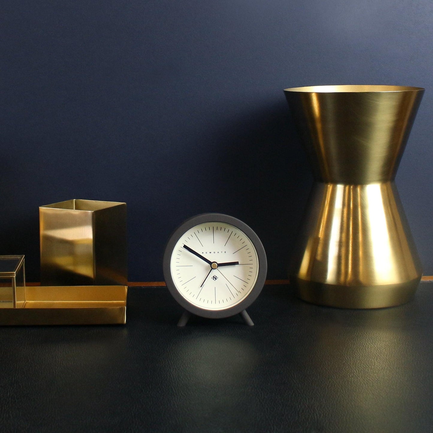 Chocolate black alarm clock with cream face, black hands, and gold center