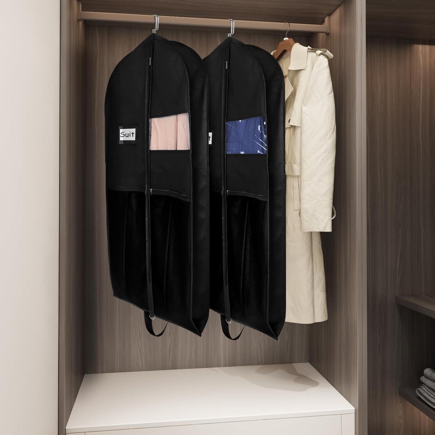 Black hanging suit garment bags in closet with zipper fronts and clear card windows