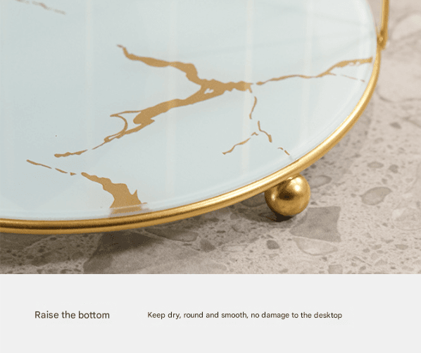 Round gold base foot on marble-effect glass tray with gold veining