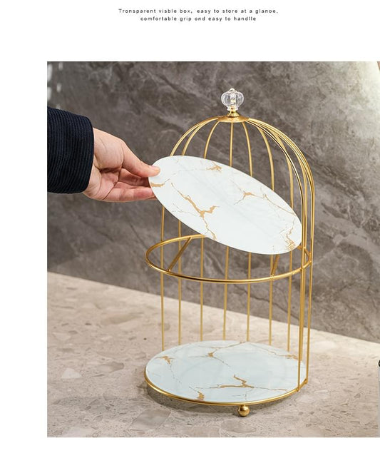 Two-tier birdcage organizer, gold frame with white marble trays; top tray lifted by hand