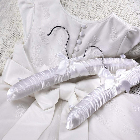 White satin padded kids hanger with bow detail, curved metal hook and shoulder knobs