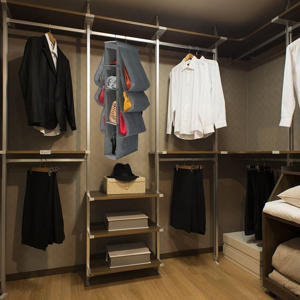 Gray hanging purse organizer on closet rail with multiple storage pockets