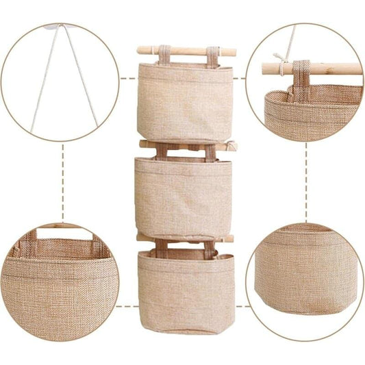 Hanging storage organizer bag with three stacked pockets, beige fabric, wooden hanging bars