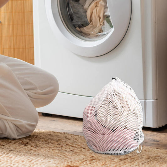 White mesh delicates wash bag with drawstring, shown standing on floor
