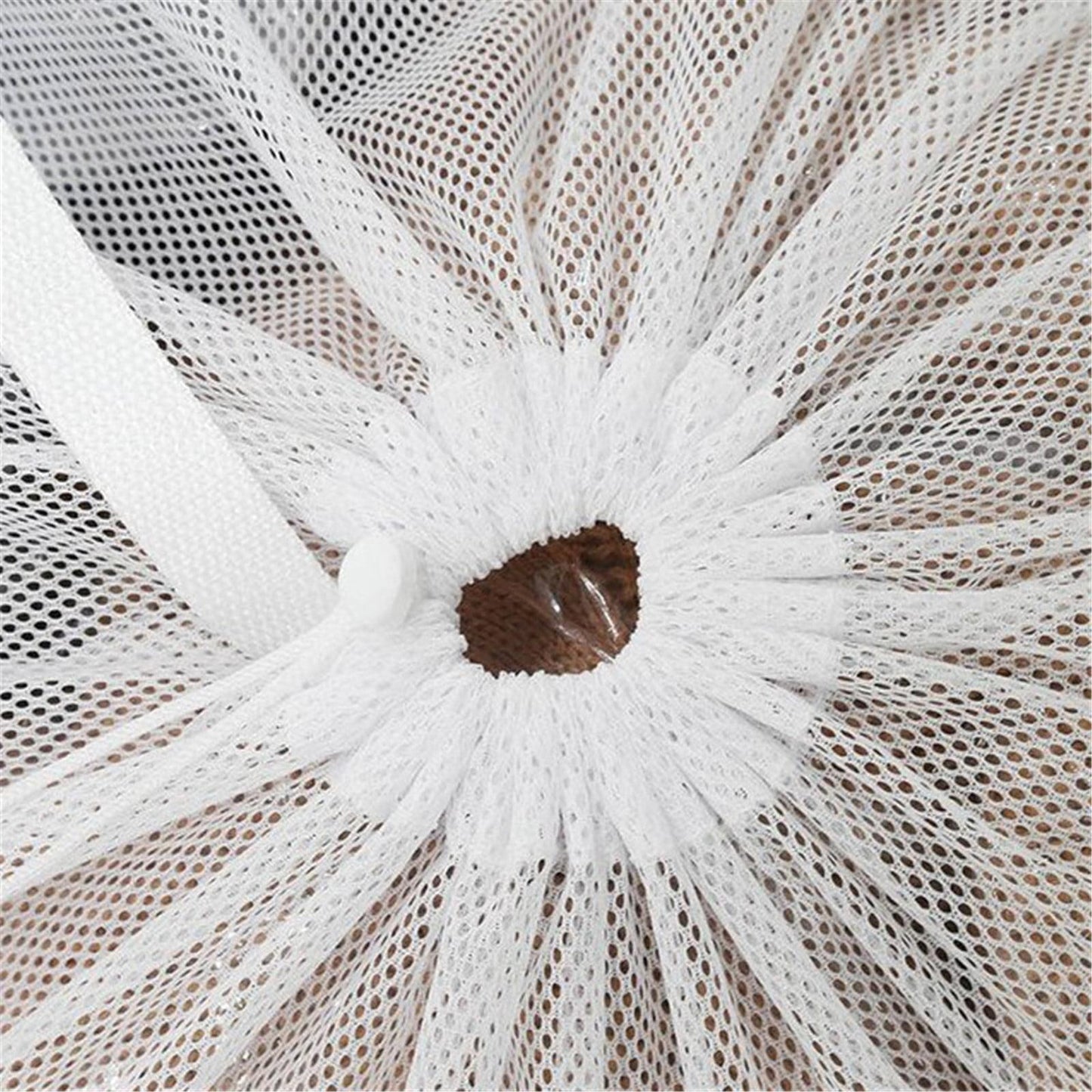 Delicates laundry bag opening, white mesh gathered with drawstring knot