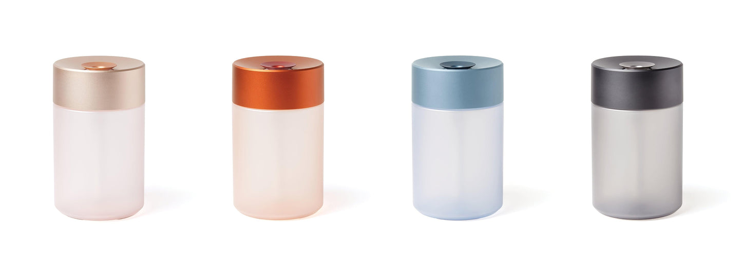 Aromatherapy humidifier in multiple colors: orange, blue, and dark-top variants.