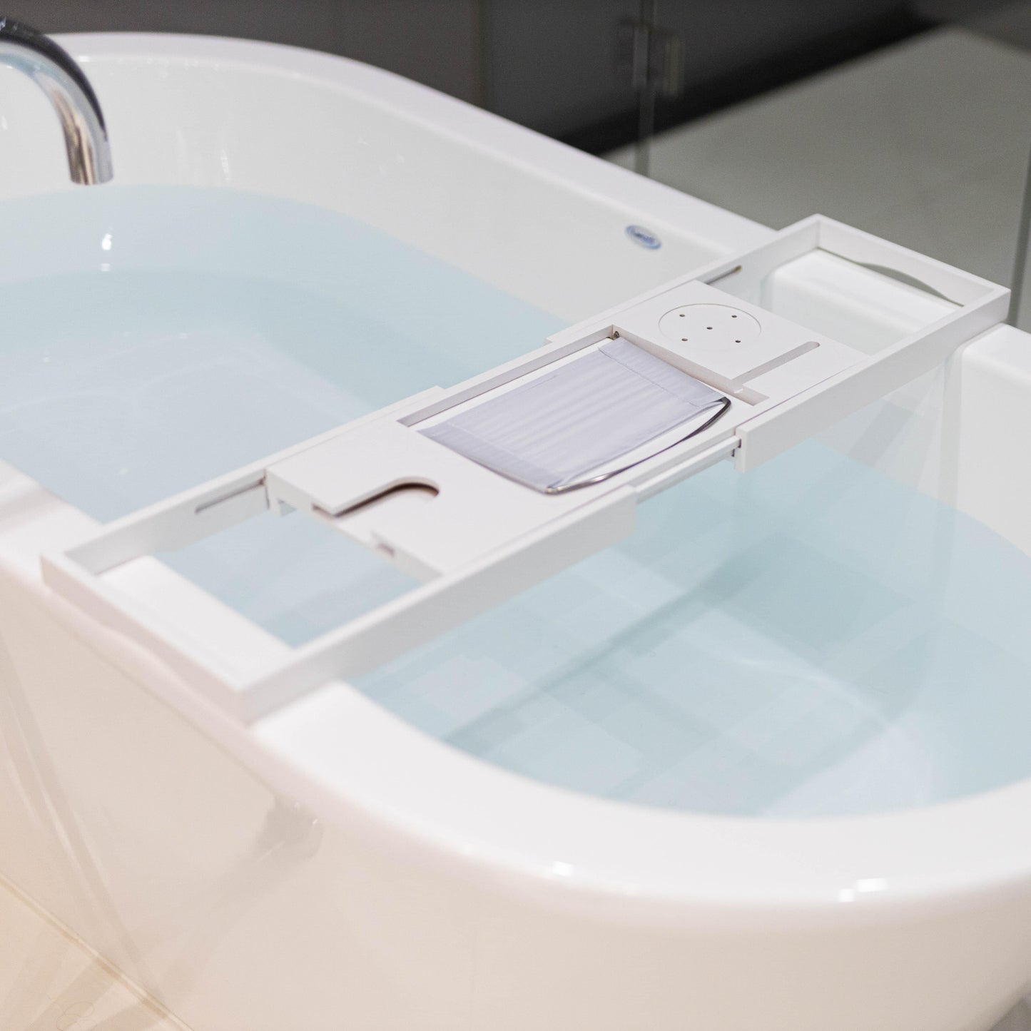 White bamboo bath caddy extension with drainage slots and towel rail