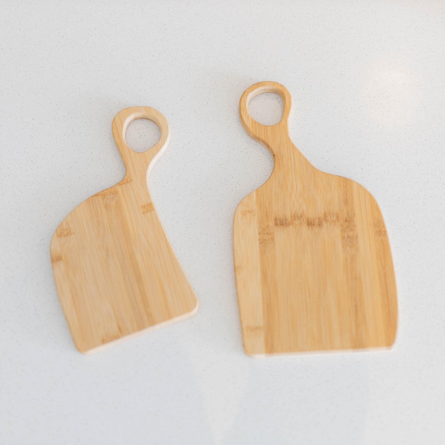 Set of 2 bamboo chopping boards with loop handles, side by side