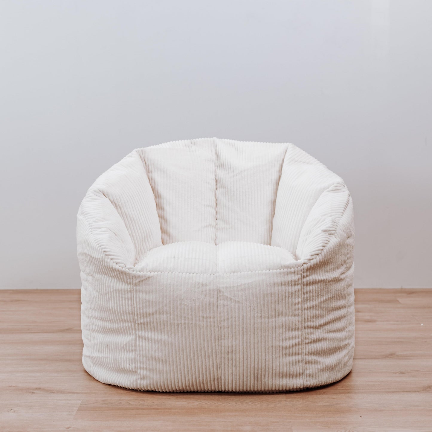 Ivory ribbed corduroy tub chair bean bag cover, front view of rounded cushion