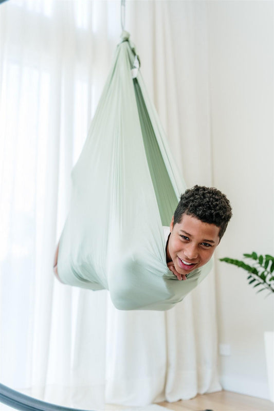 Sage green hanging hammock-style swing cocoon with braided top rope, close view