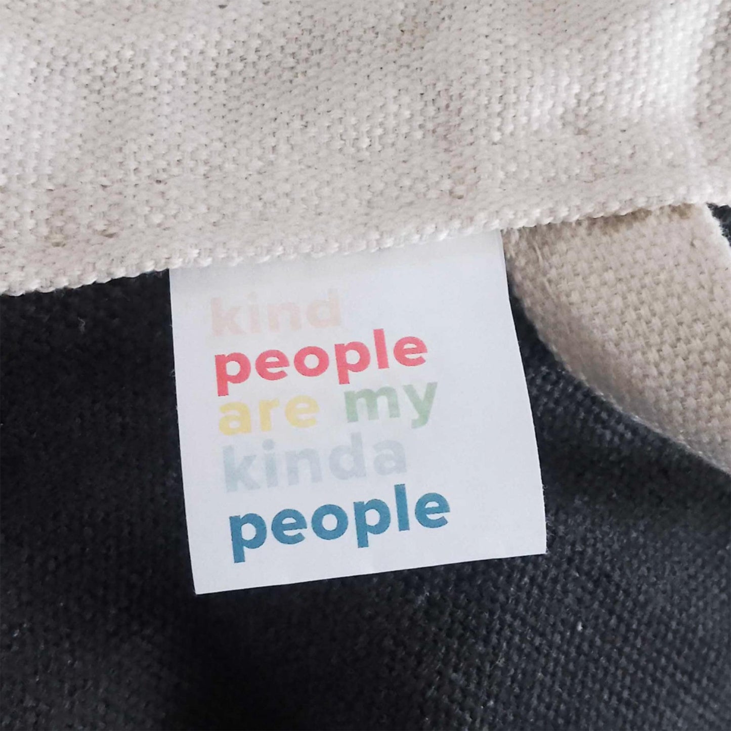 Fabric label on pod reading 'kind people are my kind people'