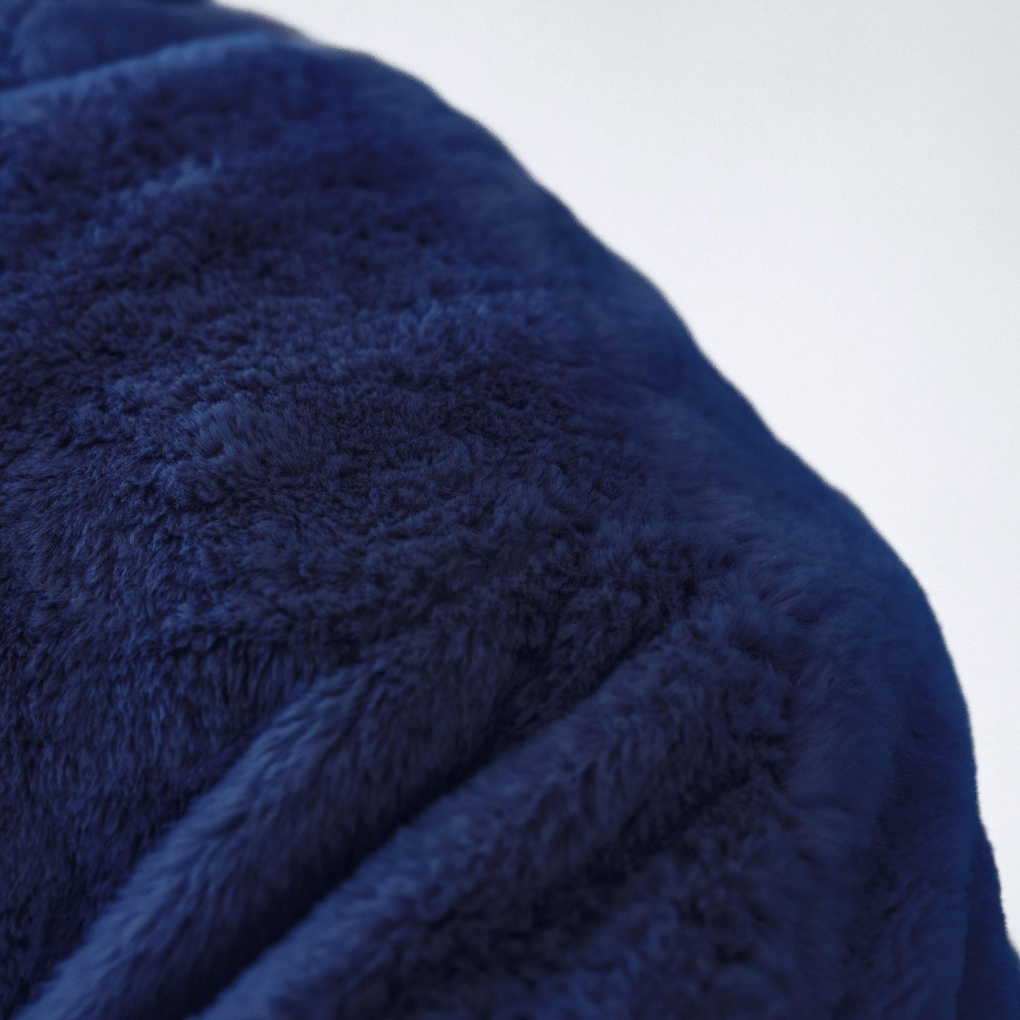 Cloud plush fur bean bag fabric close-up, dark navy fuzzy texture