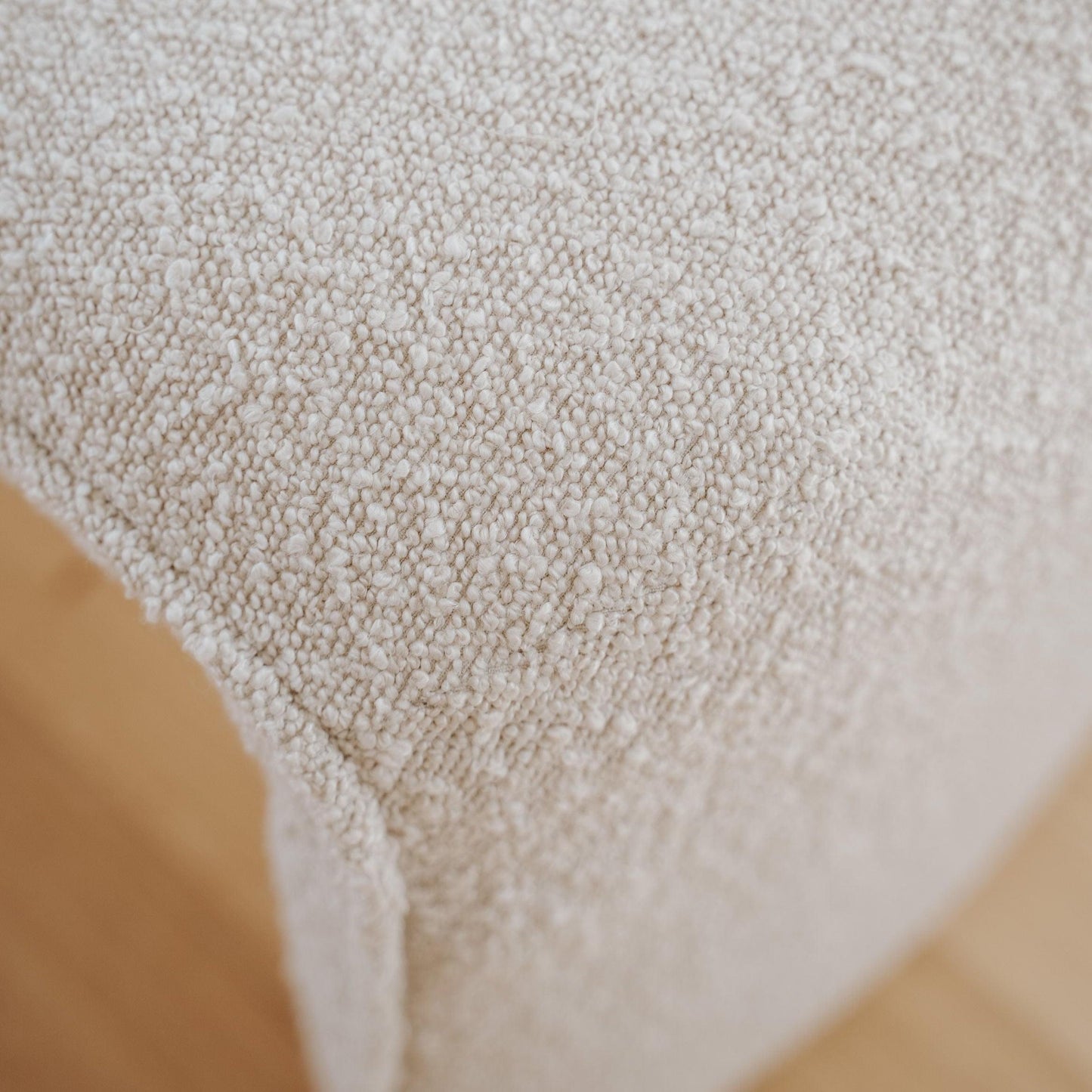 Close-up of champagne boucle upholstery texture on bench seat