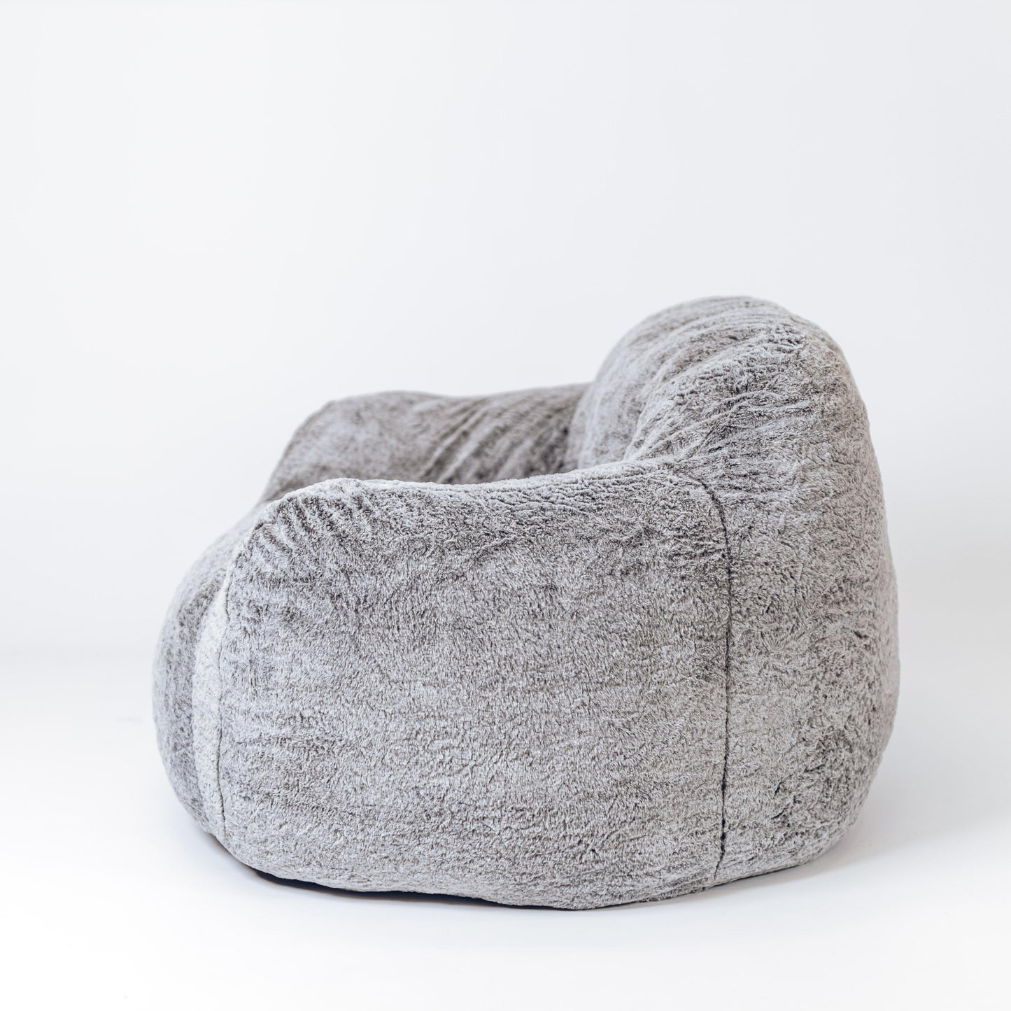 Alpine grey plush lounge chair side view with thick padded arms