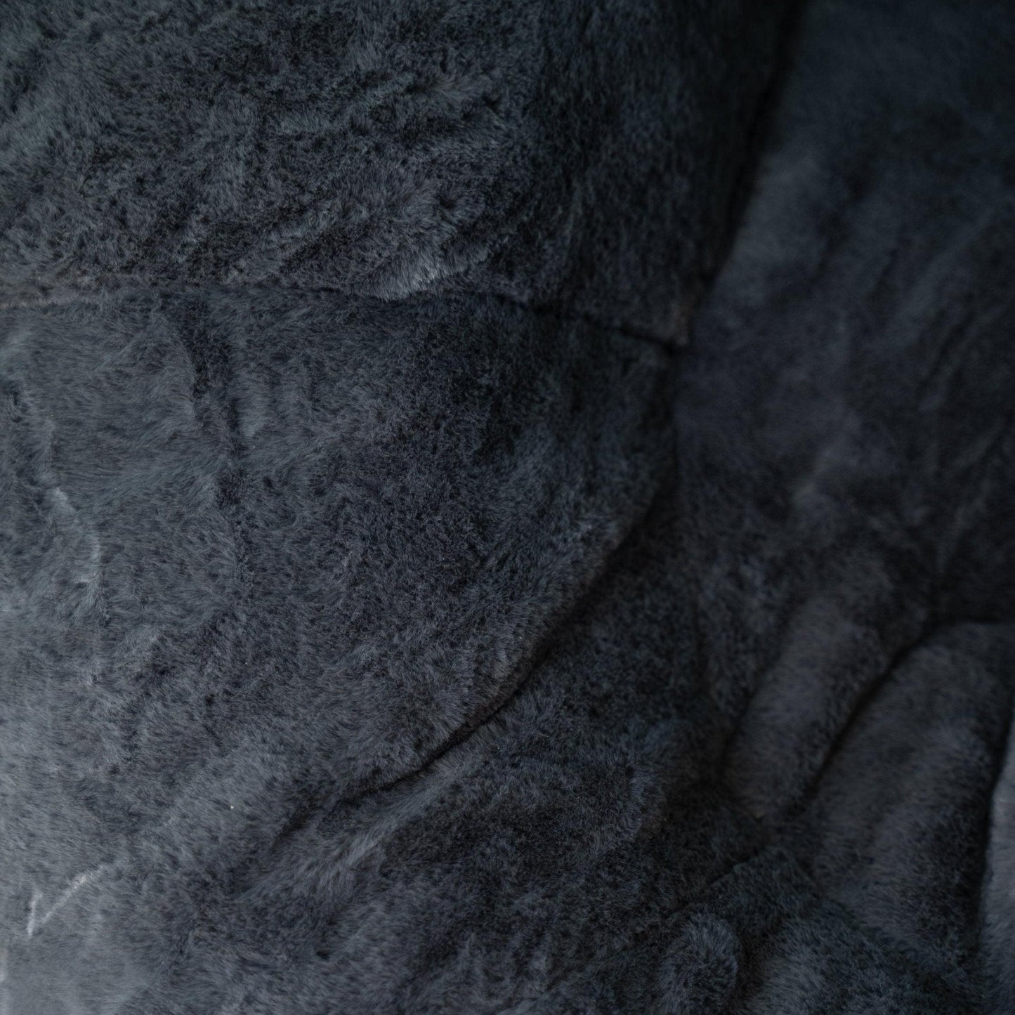 Charcoal gray plush fabric texture on round beanbag nest lounger