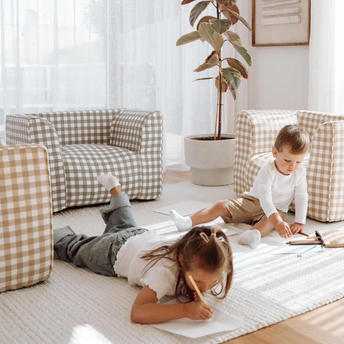 Grey gingham beanbag chair with squared back and arms, kids playing nearby