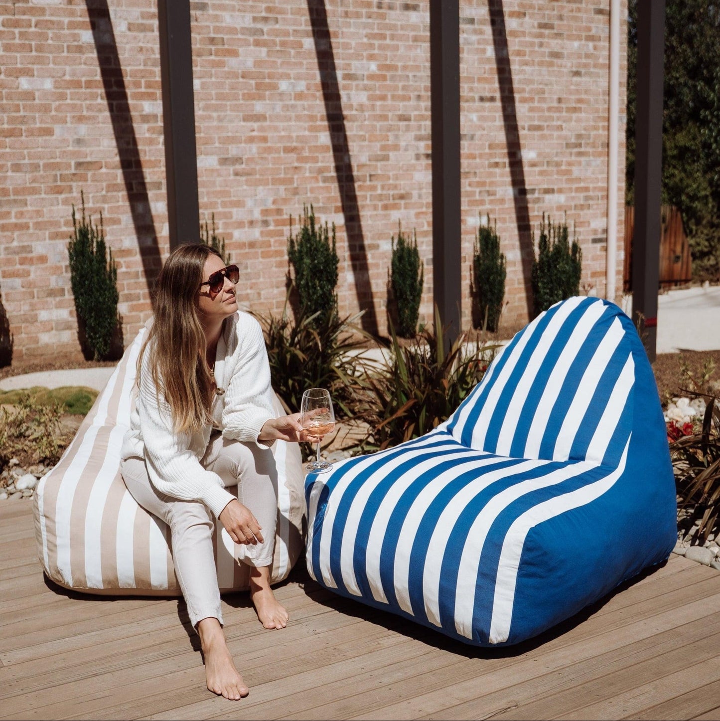 Outdoor bean bag chair with blue and white vertical stripe cover