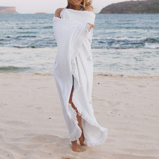 White round beach towel worn as a shawl with tassel fringe