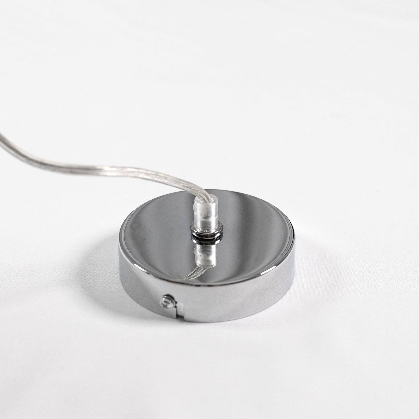 Chrome ceiling canopy with attached cord for glass cylinder pendant light.
