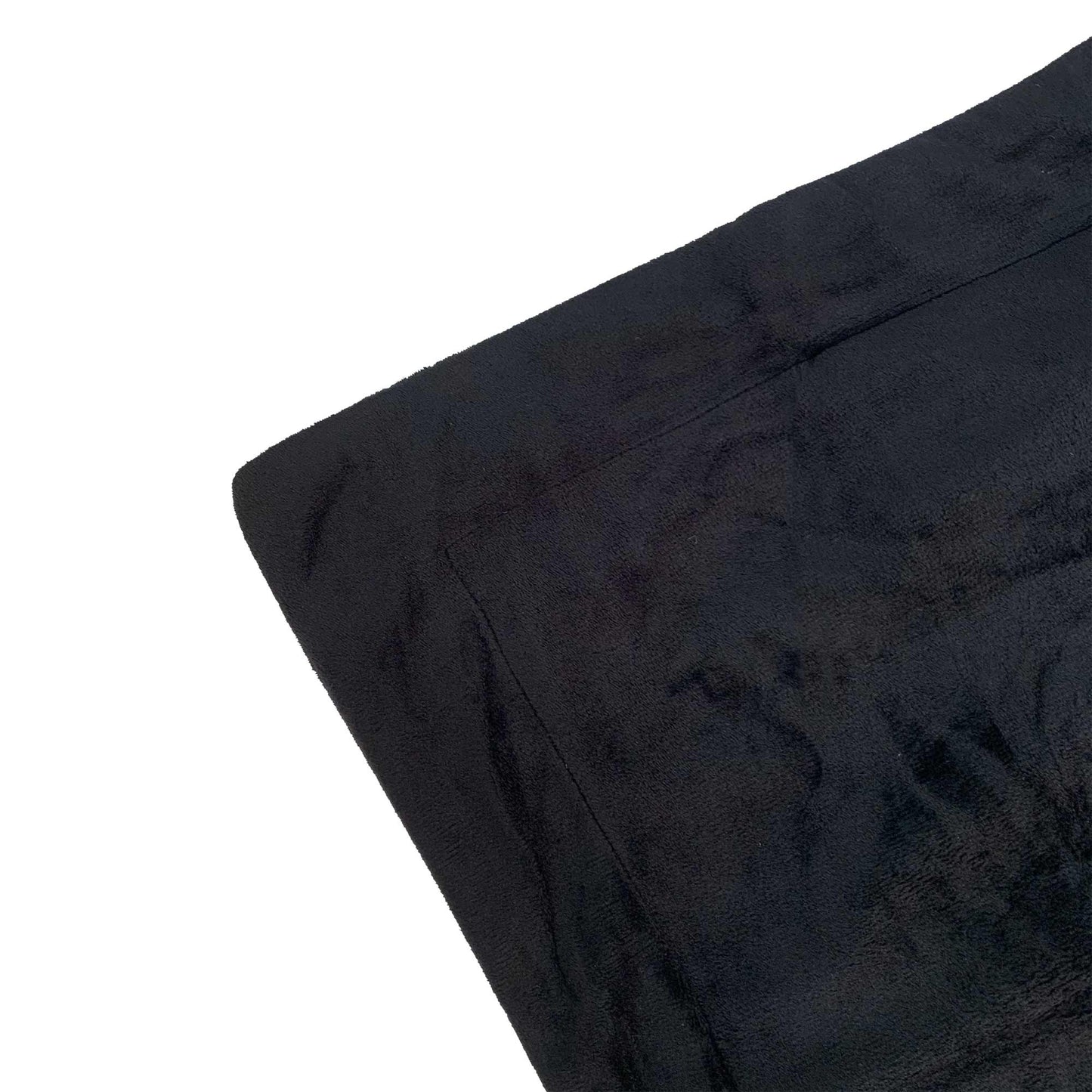 Black fur velvet quilt cover corner close-up, smooth plush pile