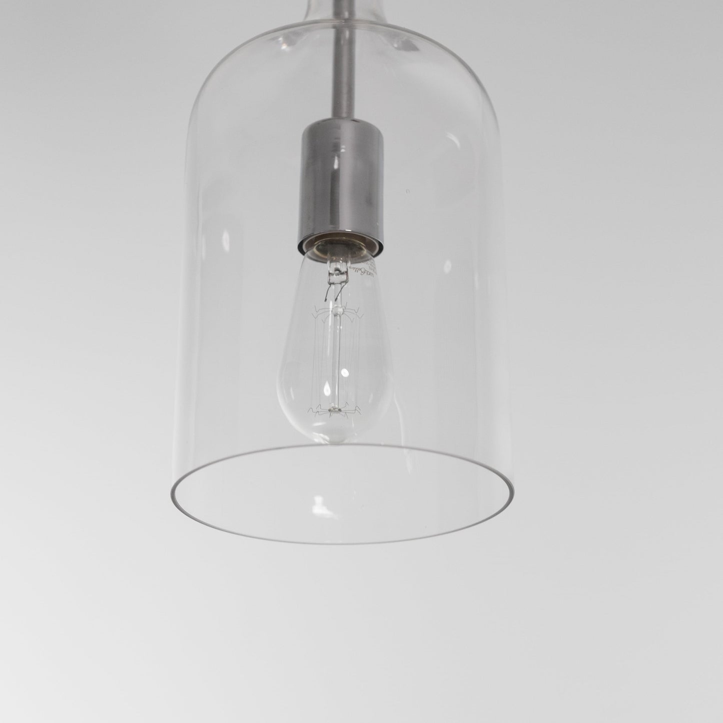 Clear glass pendant light shade with chrome top and visible bulb