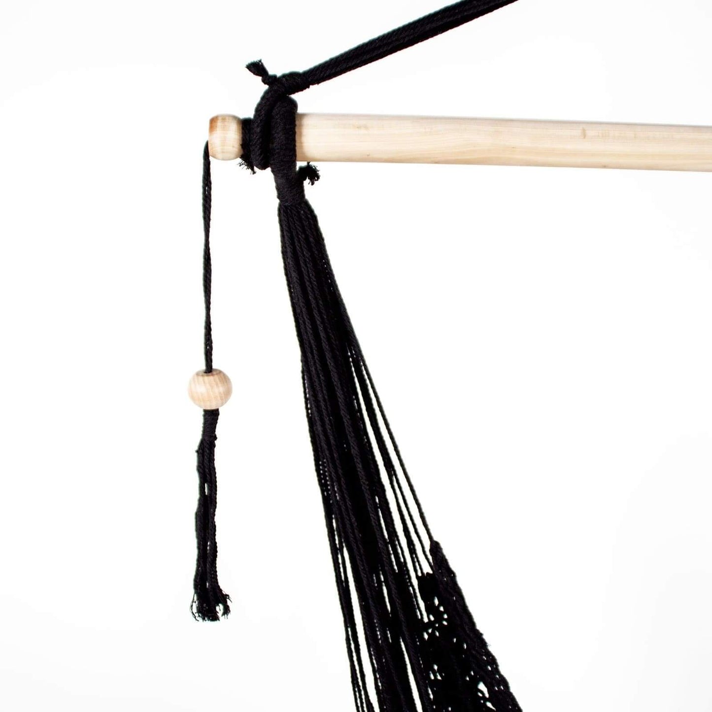 Close-up of black macrame hammock chair suspension with wooden bead and tassels