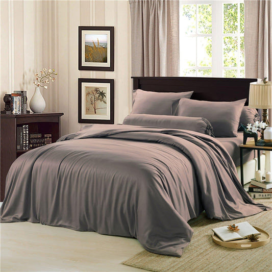 Charcoal quilt cover set on a bed with two pillowcases and fitted bedding