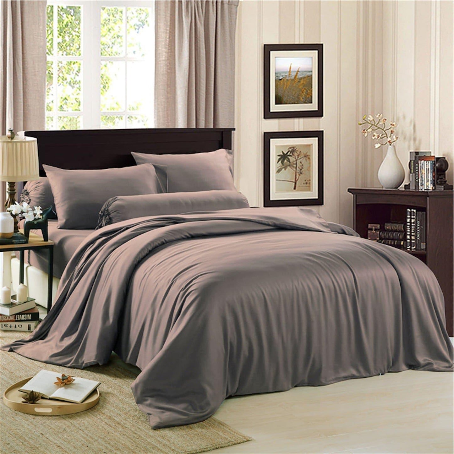 Charcoal grey bedding set on bed: duvet cover, fitted sheet, and matching pillowcases