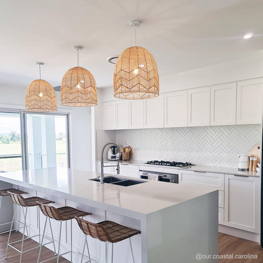Natural rattan pendant light set of three domed woven shades suspended over kitchen
