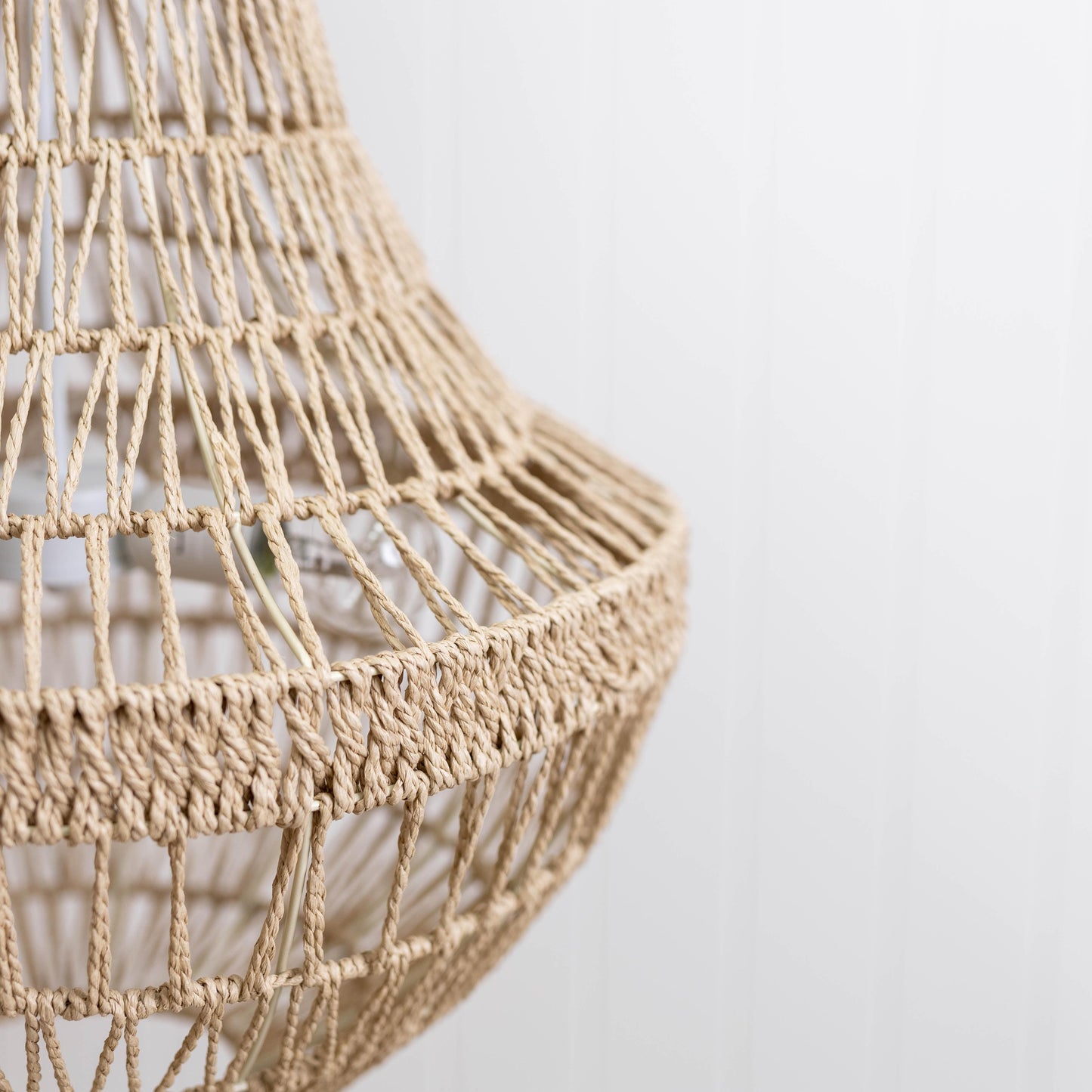Close-up corner of natural rope pendant chandelier shade with crisscross weave