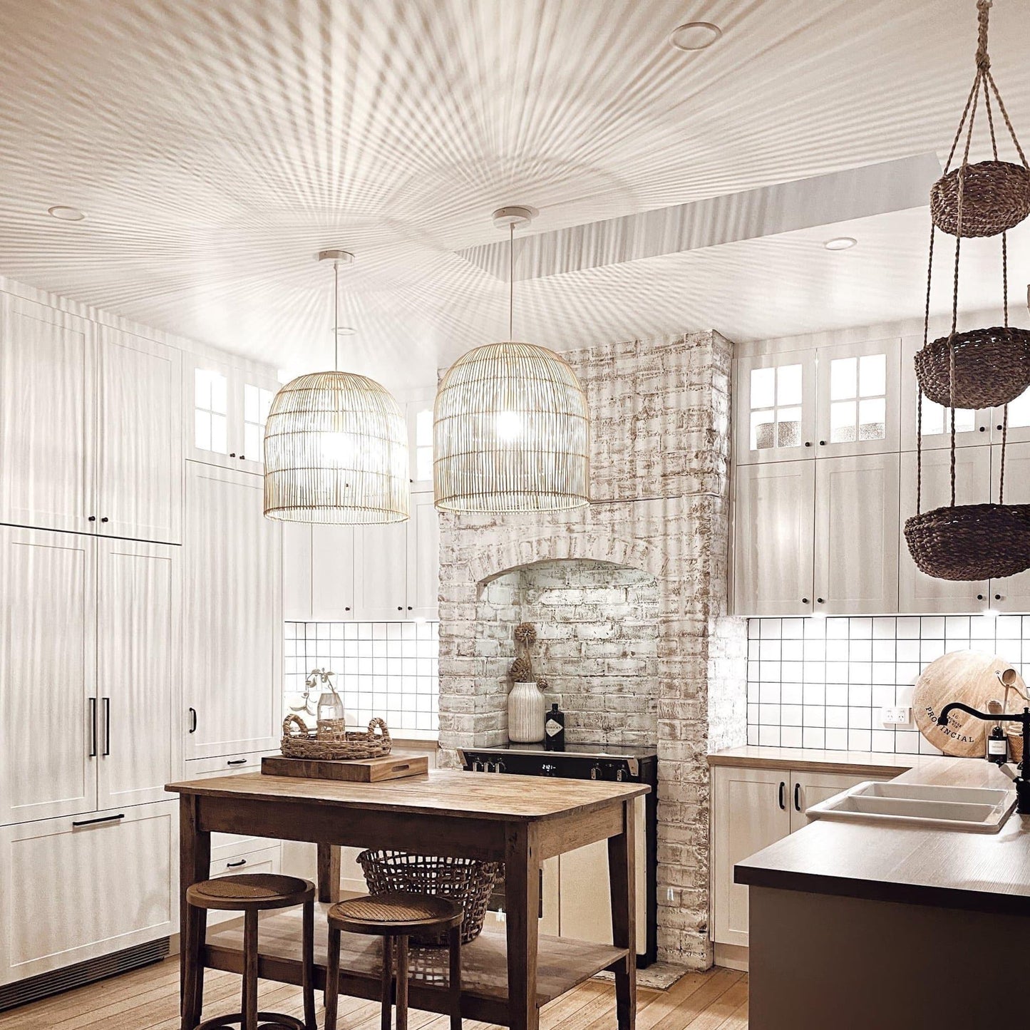 Pair of natural rattan cane pendant lights with dome cage shades