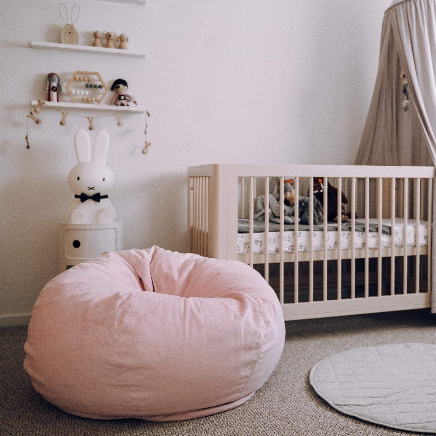 Blush pink round bean bag chair with stitched, quilted panels