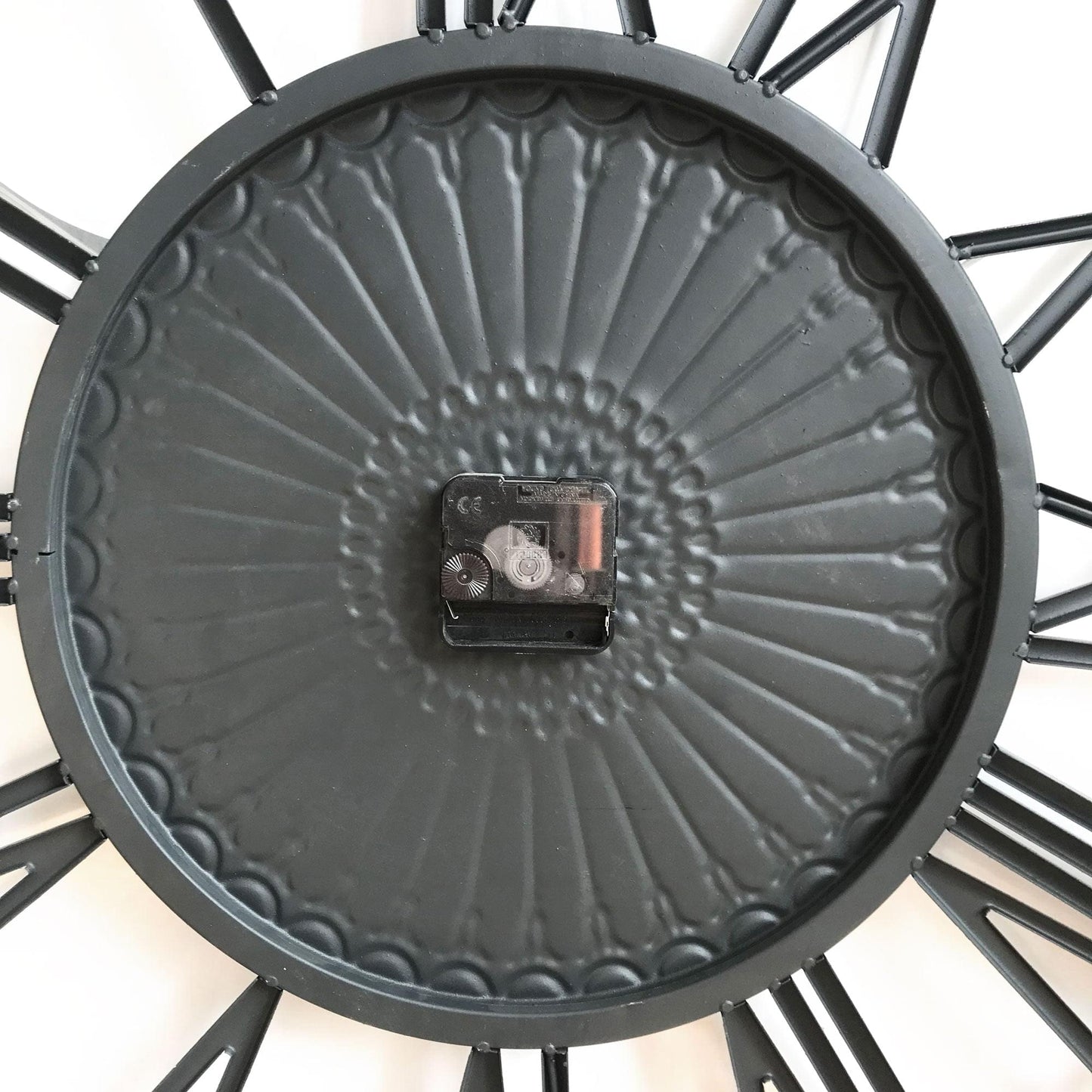 Charcoal metal clock back with battery compartment centered inside the round frame