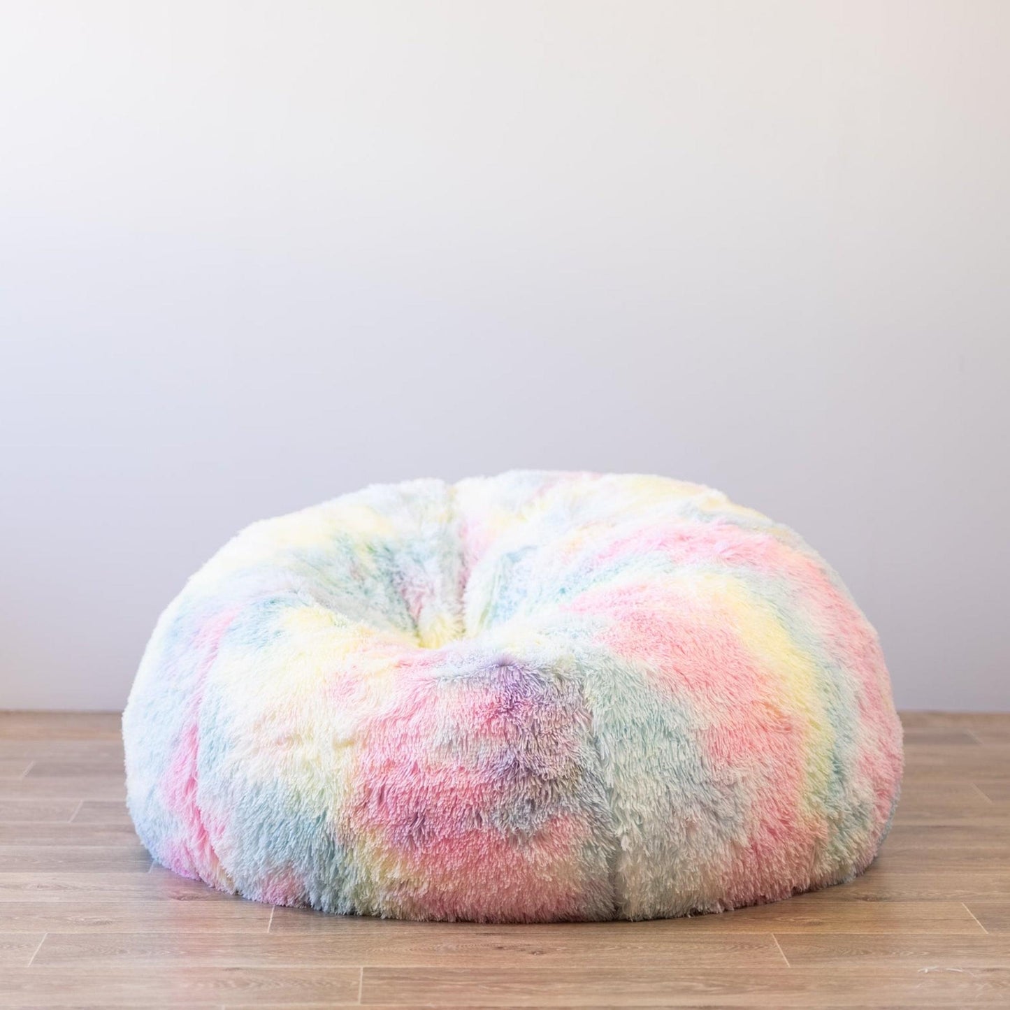 Rounded rainbow tie-dye shag faux-fur bean bag with plush, smooth outer surface